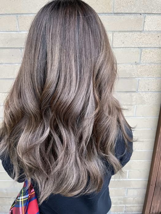 Long ash-blonde hair colored and styled at Salon 206